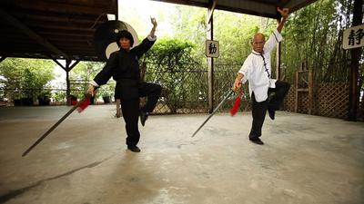 Grandmaster Chan and wife, Suzy Chan practice sword